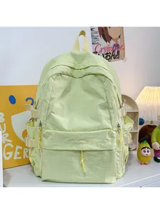 Close-up of light green nylon backpack with KAYILD embroidery and yellow top handle strap