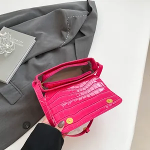Rose red crocodile embossed leather flap bag with gold magnetic snaps and chain strap