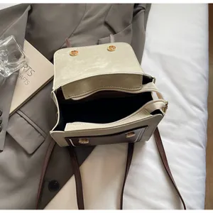 Top view of retro color-block handbag showing dual storage compartments and magnetic flap