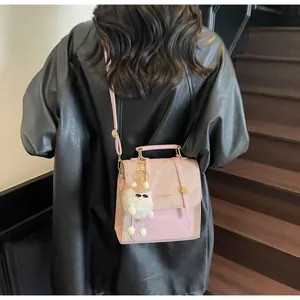 Pink crossbody bag featuring a cute white lamb pendant and stylish London logo print