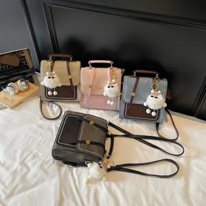 Retro multi-functional backpack in four colors with plush pendant on a white bed