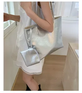 Détail du sac cabas argenté métallisé avec texture froissée et pochette assortie