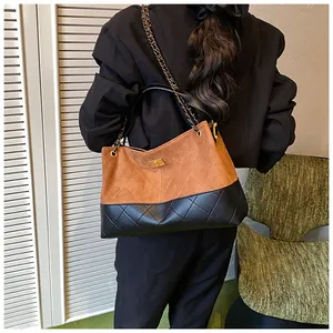 Vue détaillée du sac cabas bicolore avec motif matelassé et chaîne dorée