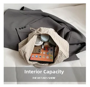 Internal capacity of beige checkered tote bag showing space for tablet and phone