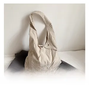 Detail shot of apricot checkered tote bag with a bow knot, showing fabric texture