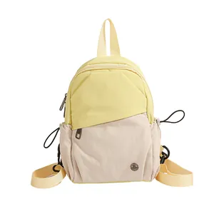 Minimalist yellow and beige nylon mini backpack with adjustable straps and side pockets