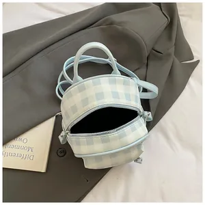 Detail view of mini light blue gingham barrel bag with top handle and double zippers