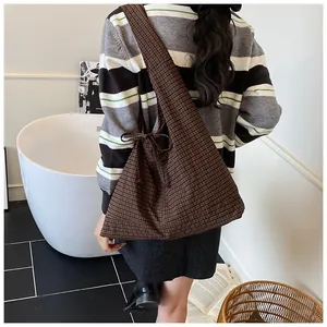 Detail of coffee brown checkered tote bag with ribbon bow and large storage capacity