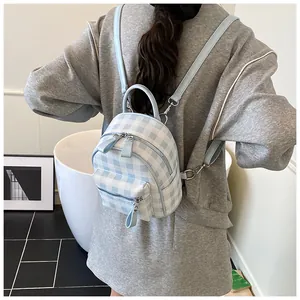Detailed back view of a blue and white gingham mini backpack with adjustable straps