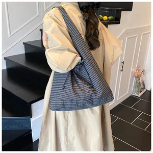 Large capacity plaid tote bag with side drawstring details shown from a side view