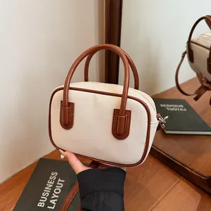 Retro cream canvas Boston bag with brown leather trim and top handles for daily work use