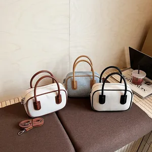 Three-color mini Boston bowling bags in canvas with leather handles and crossbody straps