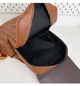 Interior view of brown faux leather backpack showing spacious main compartment and lining