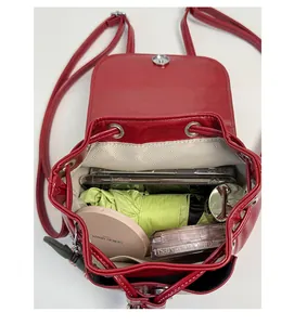 Detail view of the red leather bucket backpack interior with drawstring and magnetic closure