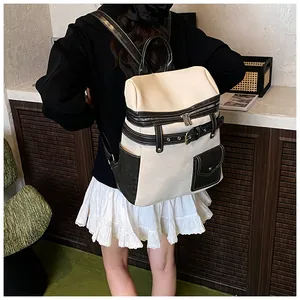 Detail of cream canvas backpack with black leather straps and functional metal buckles
