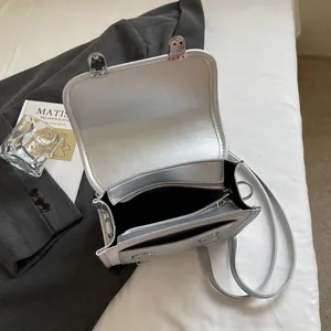 Silver metallic crossbody bag with glossy PU finish and black fabric inner lining