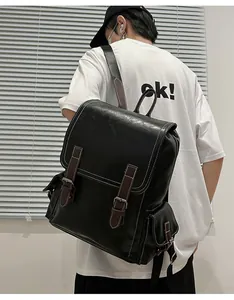 Close-up of black PU leather backpack with brown straps and white contrast stitching