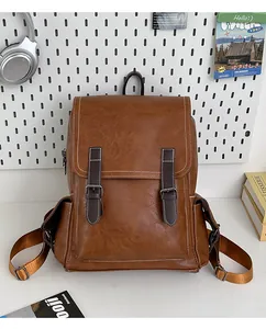 Detail view of brown vintage PU leather backpack with contrast stitching and side pockets