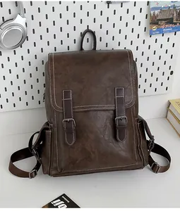 Detail of vintage brown leather backpack with buckle straps and side storage pocket