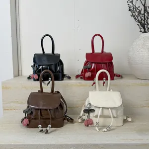 Vintage college style mini backpacks in black, red, brown, and white with cherry charms