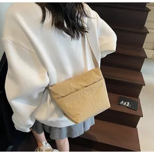 Detailed back view of a khaki casual crossbody bag with pleated texture and fabric strap