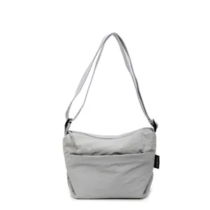 Minimalist light grey waterproof nylon crossbody bag with adjustable strap and casual design