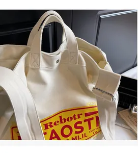 Close-up of cream canvas tote bag with vintage red and yellow lettering for students