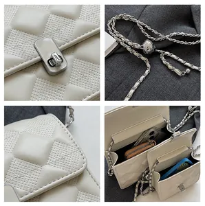 Detail view of beige quilted bag showing silver twist lock and adjustable chain