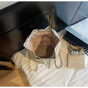 Spacious interior of beige drawstring bucket backpack showing high capacity storage room
