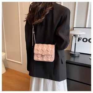 Detail of pink quilted chain bag featuring silver metal twist lock and textured finish