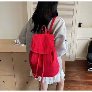 Close-up of a vibrant red drawstring backpack featuring a durable fabric texture