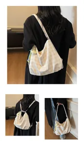 Vue détaillée du sac en toile à carreaux montrant les options de porté épaule et sac à dos