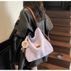 Lavender canvas hobo bag with brown leather straps and cute capybara pendant detail