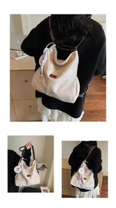 Detail of off-white tote bag with dark brown straps and decorative colorful beads