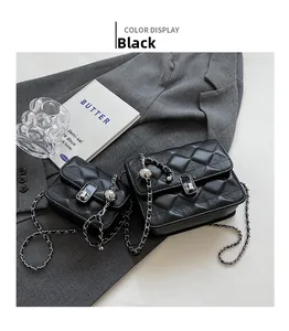 Macro view of black quilted faux leather chain bags in large and small sizes with silver lock