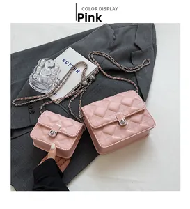 Macro detail of pink quilted faux leather handbags with silver turn-lock and chain straps