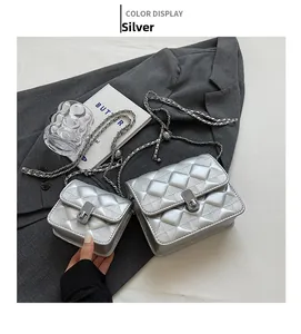 Detailed comparison of silver quilted shoulder bags in large and mini sizes with chain straps