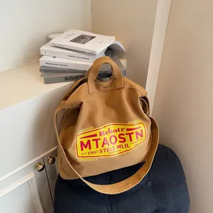 Brown canvas tote bag with vintage American print and adjustable wide shoulder strap