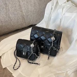 Chic black quilted crossbody bags with silver chain straps and adjustable metal balls