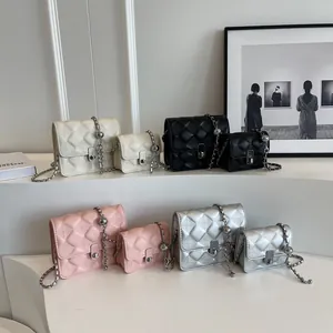 Quilted leather crossbody bags in four colors and two sizes on display stands