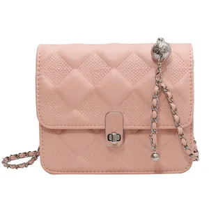 Pink quilted crossbody bag with silver chain strap and orbital metal charm details