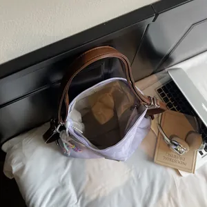 Large lavender canvas tote bag with brown straps and colorful charm for commuting