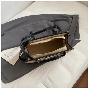 Top-down view of large capacity shoulder bag showing spacious interior and zipper pocket