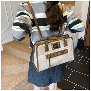 Detail view of the versatile grey and brown backpack with premium faux leather texture