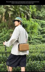 Detail of khaki nylon crossbody bag with textured fabric and woven strap for hiking