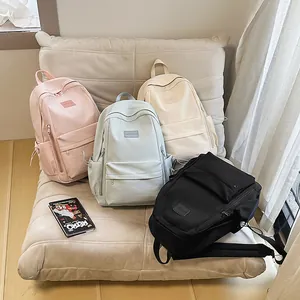 Minimalist solid color school backpack for women in pink, blue, white, and black colors