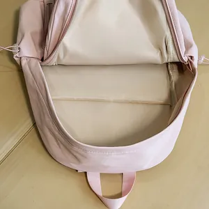 Top view of minimalist light pink backpack with laptop compartment and internal storage