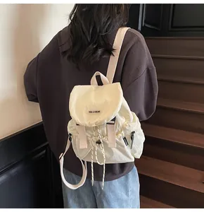 Détail du sac à dos contrasté montrant la texture en nylon et le système de serrage