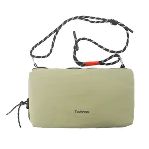 Minimalist light green nylon crossbody bag with textured strap and Taoleyou logo