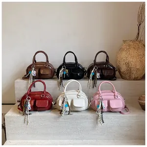 Detailed collection of colorful faux leather bowling bags on a minimalist stone display